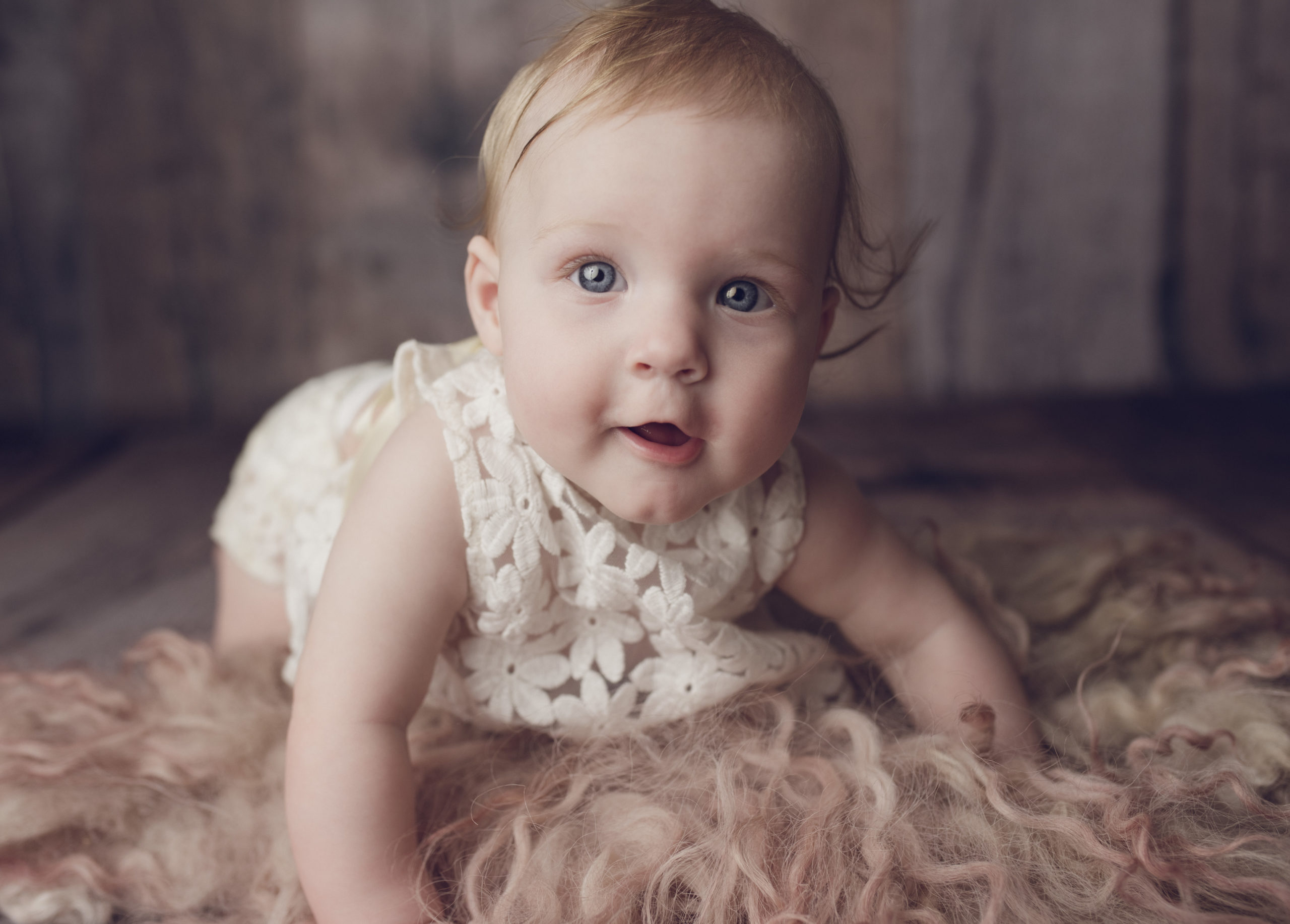 grand rapids milestone photography shoot 6 month sitter session girl with blue eyes