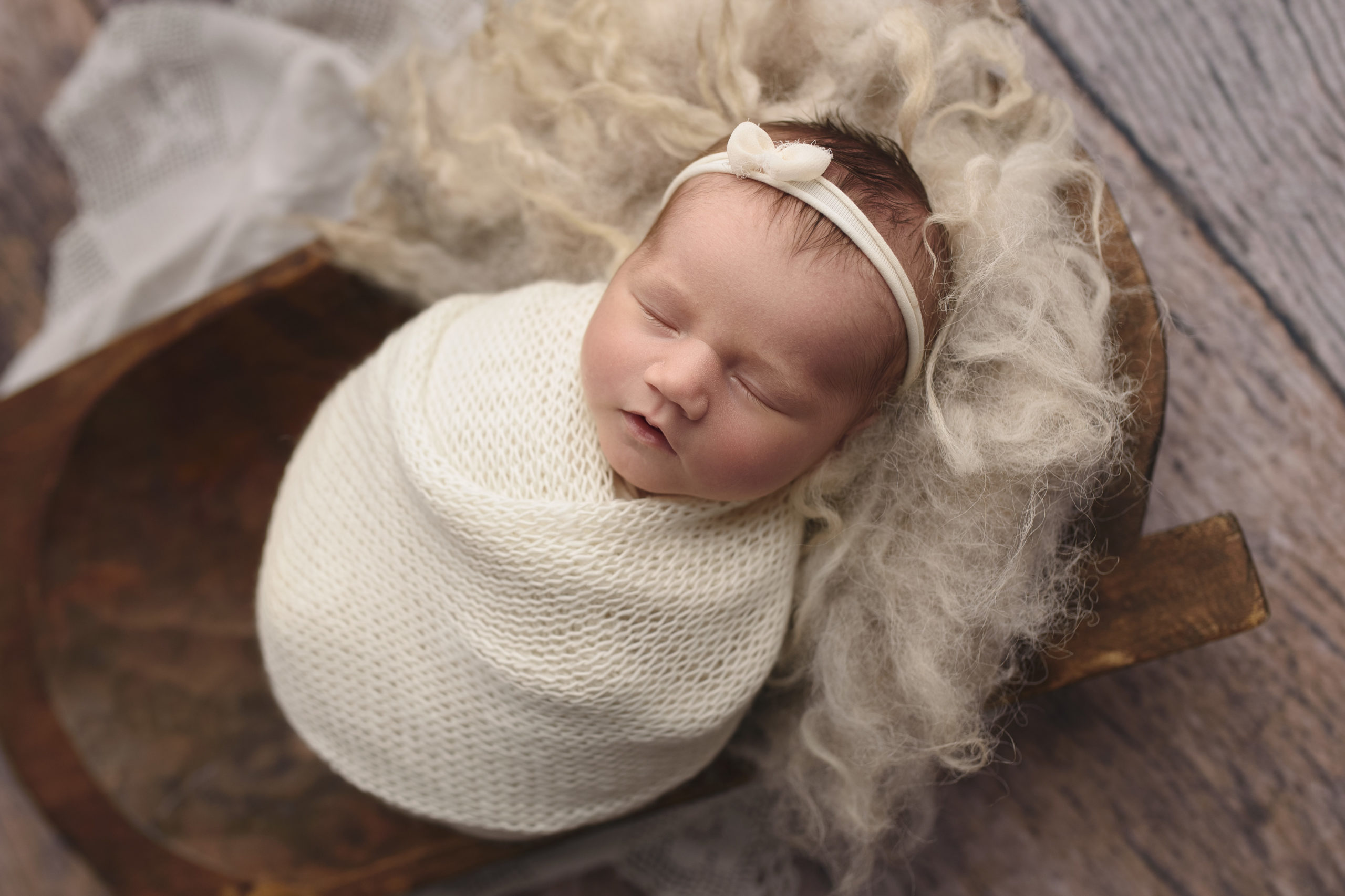 grand rapids mi newborn photography studio shoot baby sleeping in a knit wrap