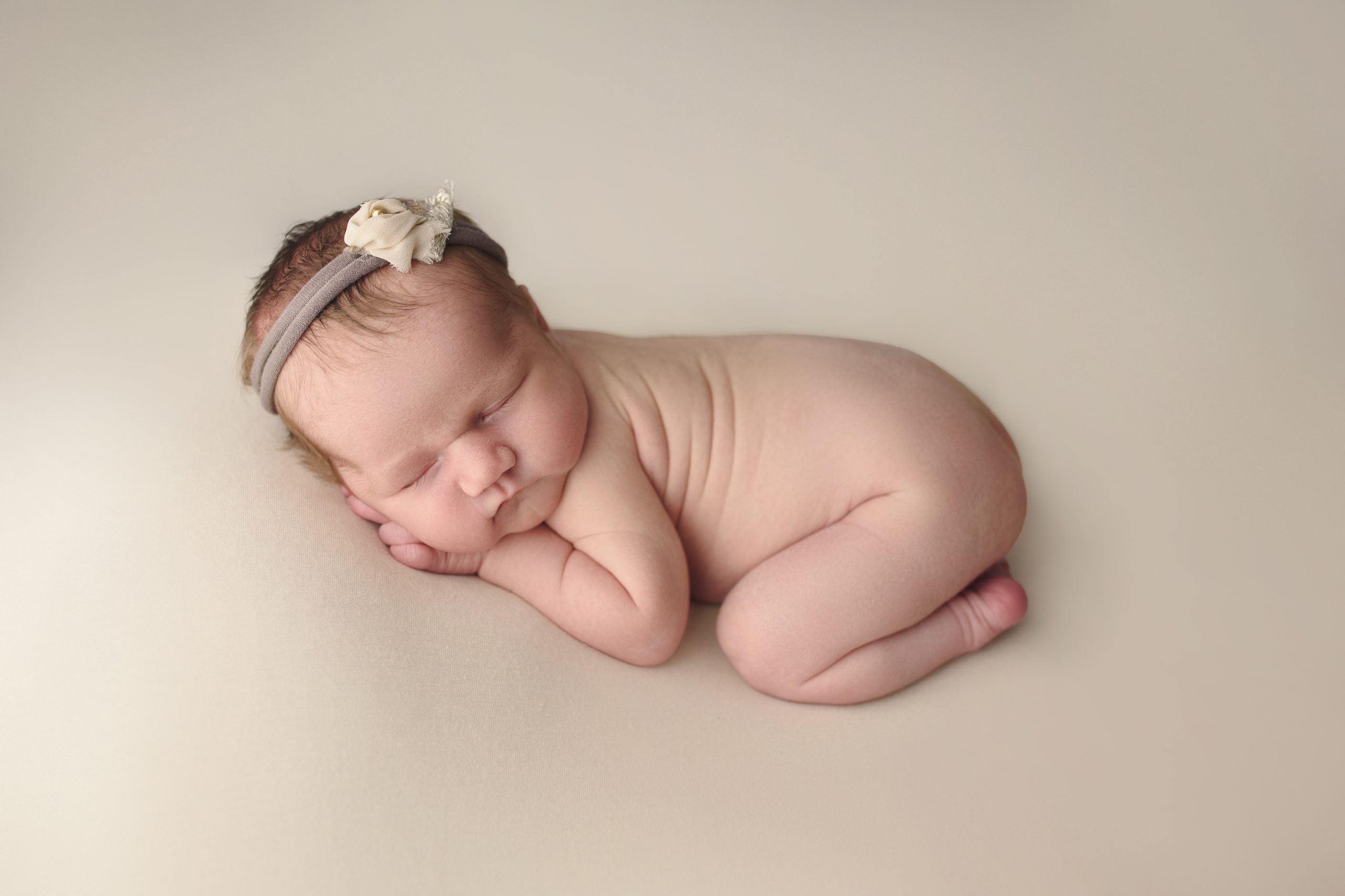 grand rapids mi newborn photography studio shoot baby sleeping on cream background
