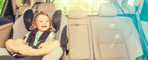 Picture of child laughing in a car seat