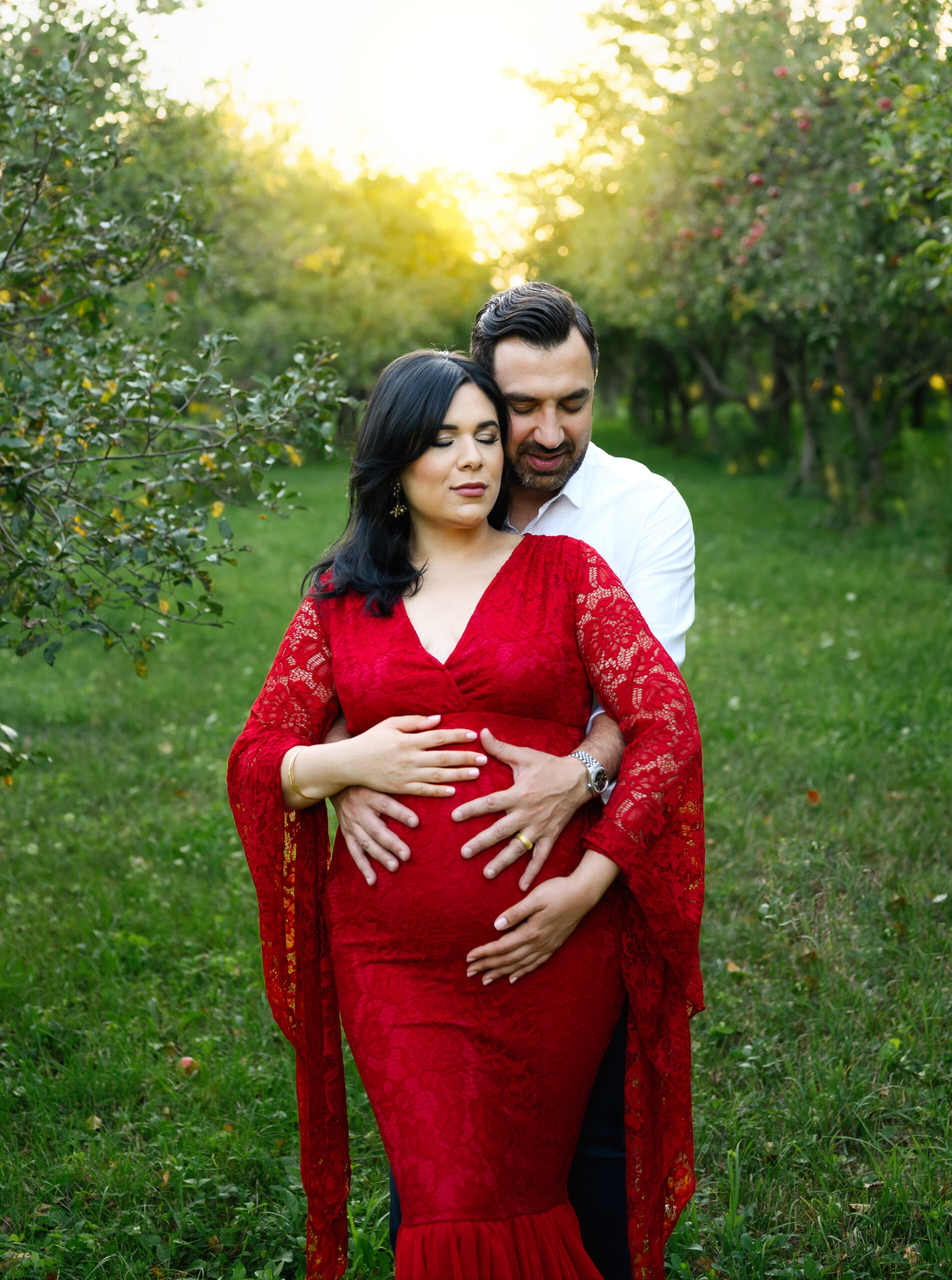 Grand rapids maternity photo session wife in red dress with husband in white shirt