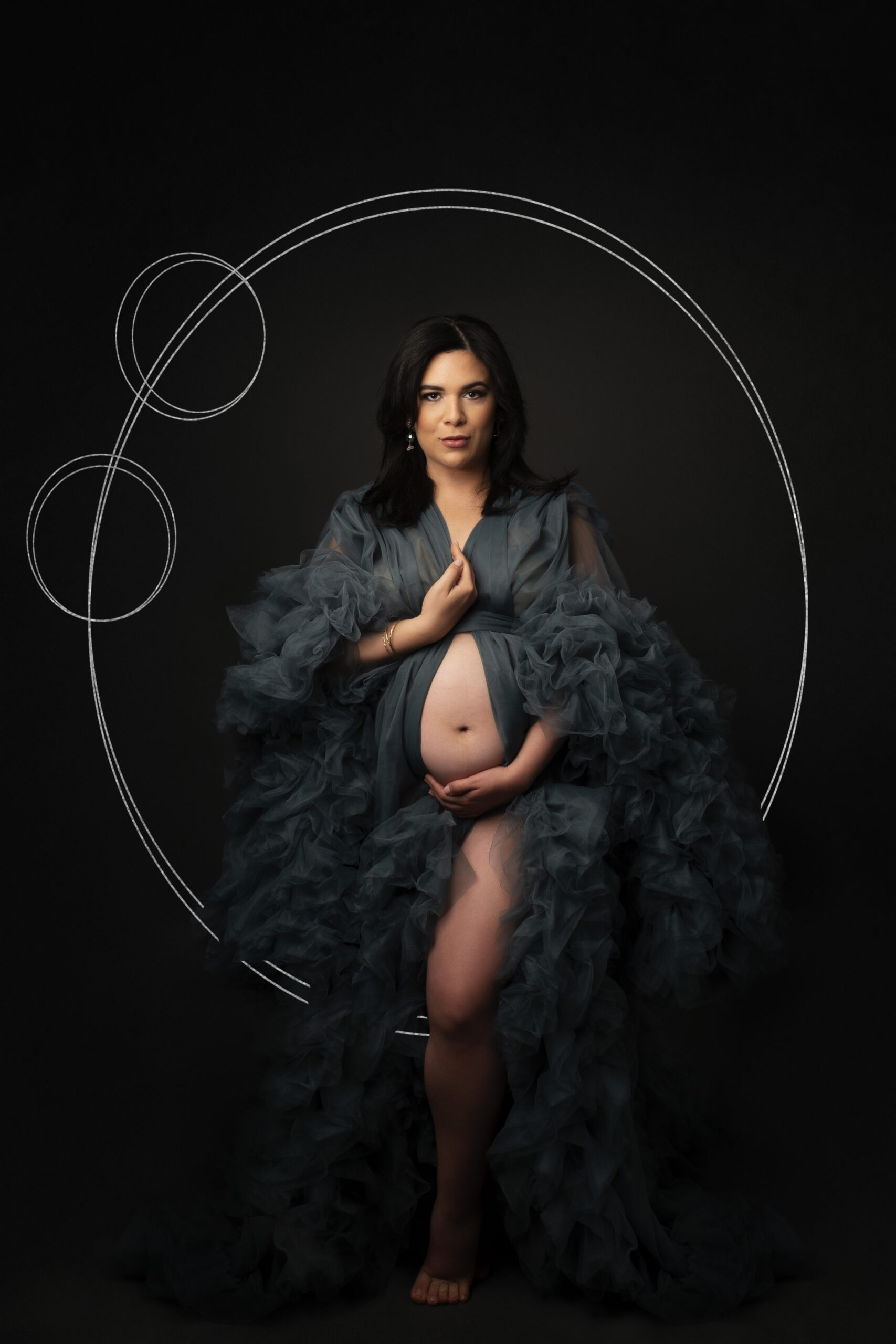 Grand rapids maternity photo session mother in grey gown with black backdrop