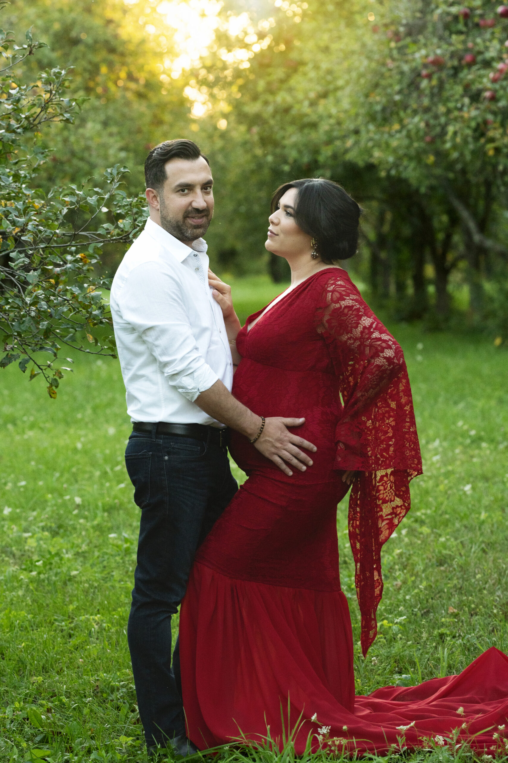 Grand rapids maternity photo session wife in red dress with husband in white shirt