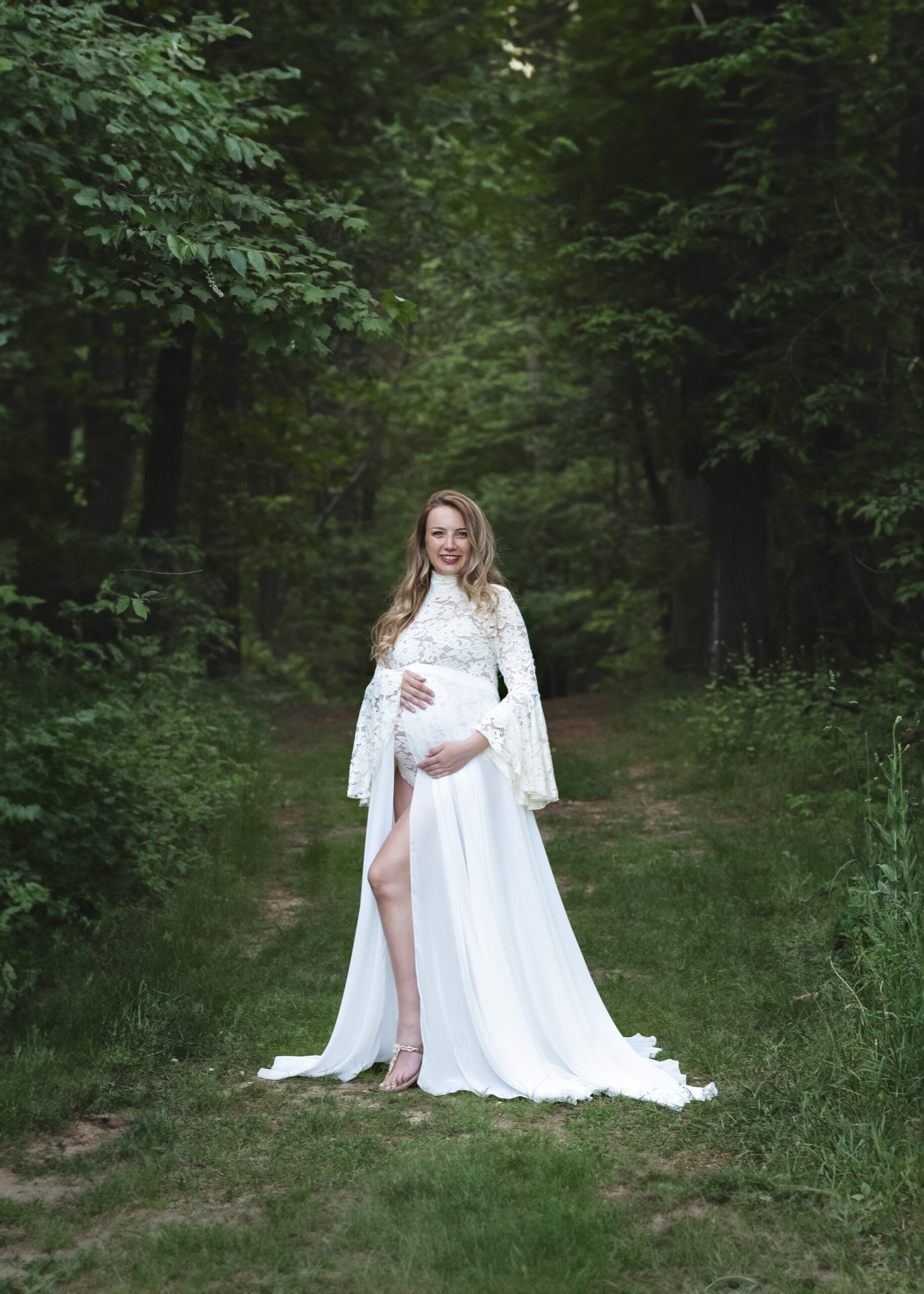 grand rapids maternity outdoor photo shoot mother in white dress in forest