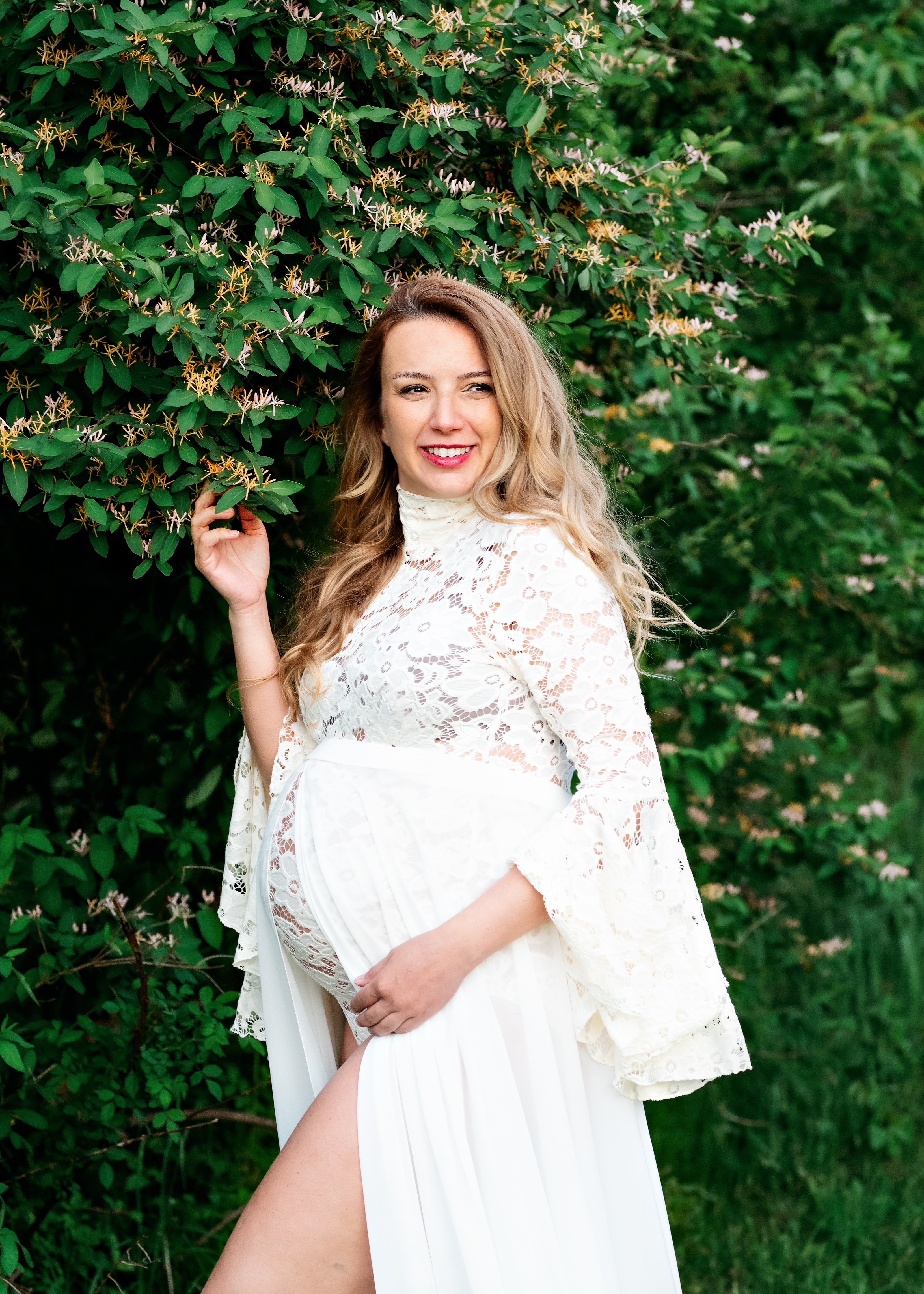 grand rapids maternity outdoor photo shoot mother in white dress next to tree