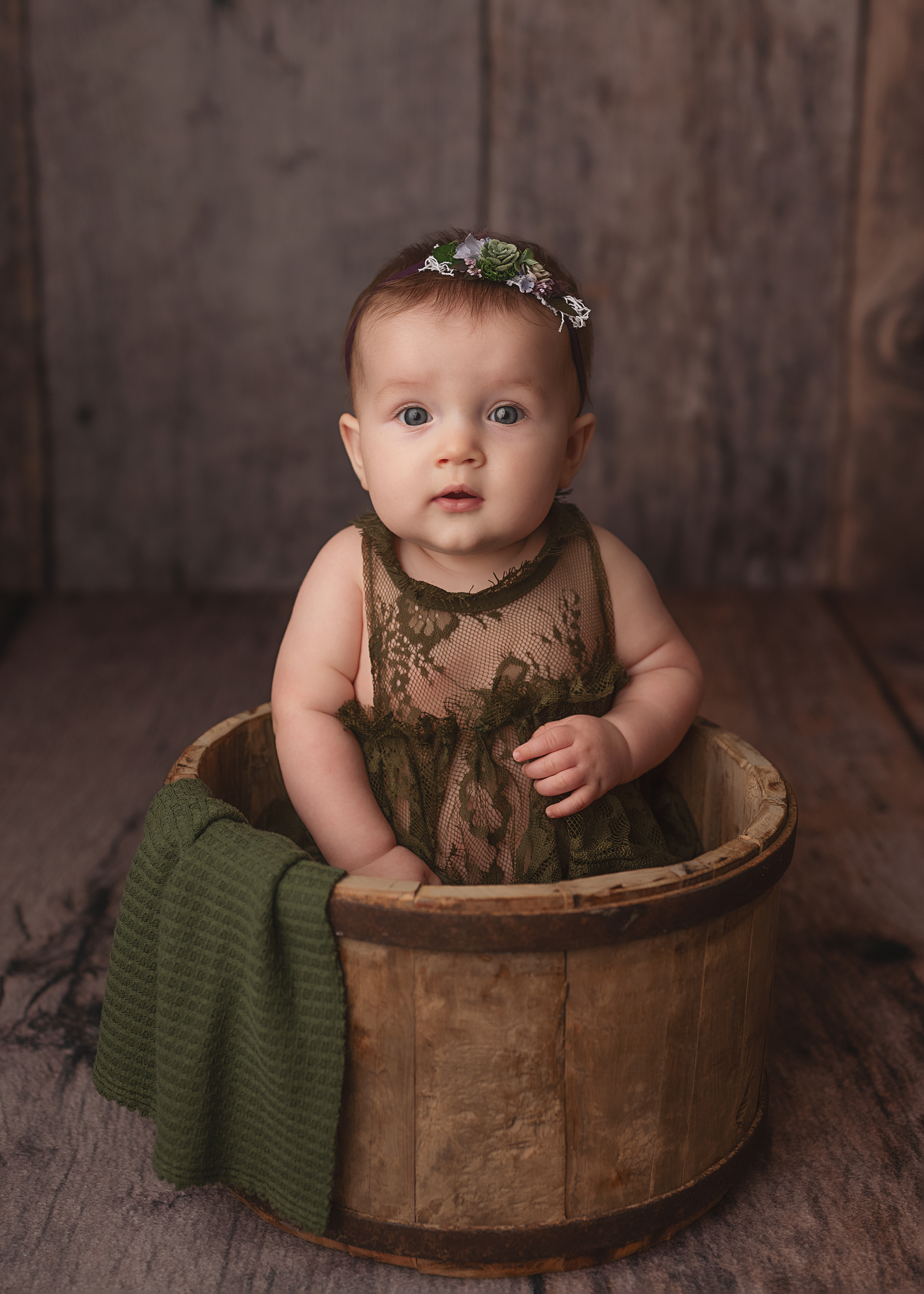 grand rapids baby photo session sitter baby girl in green dress smiling